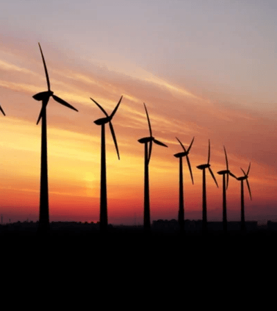 Several Wind Turbines in a sunset